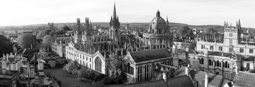 A black and white photograph of Oxford University from a nearby rooftop.