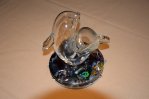 Small blown glass sculpture of two dolphins on cast glass base.