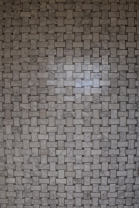 Small white marble tiles with grey veins in basketweave pattern