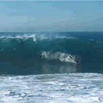 A boogie-boarder rides a wave at The Wedge in Newport Beach, California.