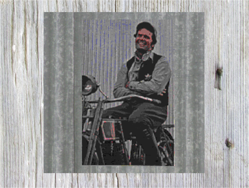 James garner as Nichols sitting on an early Harly Davidson motorbike.